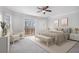 Bright main bedroom boasts a private balcony and neutral decor for a relaxing retreat at 7985 Thunder River Way, Cumming, GA 30028