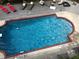 Inviting in-ground pool surrounded by a wooden deck and lounge chairs perfect for relaxation at 7985 Thunder River Way, Cumming, GA 30028