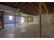 Unfinished basement with support beams, ductwork, and concrete flooring ready for renovation at 2609 Colonial Dr, Atlanta, GA 30337