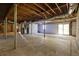 Spacious unfinished basement with support beams, concrete floors, and utilities ready for customization at 2609 Colonial Dr, Atlanta, GA 30337