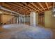 Unfinished basement offers potential for customization with exposed wooden ceiling beams and concrete floor at 2609 Colonial Dr, Atlanta, GA 30337