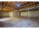 Unfinished basement with concrete floors, exposed ceiling, and utility hookups ready for customization at 2609 Colonial Dr, Atlanta, GA 30337