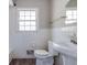 Full bathroom with toilet, pedestal sink, and tiled walls, offering a clean and functional space at 2609 Colonial Dr, Atlanta, GA 30337