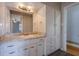 Bathroom vanity with storage, granite countertop, and a modern faucet fixture at 2609 Colonial Dr, Atlanta, GA 30337
