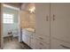 Bathroom vanity with drawers and cabinets for storage with a neutral countertop and stainless fixtures at 2609 Colonial Dr, Atlanta, GA 30337