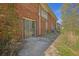 Brick building exterior showing access to a basement unit with a sliding glass door at 2609 Colonial Dr, Atlanta, GA 30337