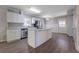 Modern kitchen with stainless appliances, a central island, and wood-look floors at 2609 Colonial Dr, Atlanta, GA 30337