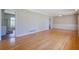 Spacious living room with gleaming hardwood floors and access to other rooms at 2609 Colonial Dr, Atlanta, GA 30337