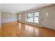 Bright living room with hardwood floors, large windows, and fresh neutral paint at 2609 Colonial Dr, Atlanta, GA 30337