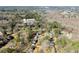 Aerial view of a residential neighborhood with mature trees, streets, and lake in the distance at 4076 Shady Nw Cir, Lilburn, GA 30047