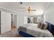 Carpeted bedroom with natural light, ceiling fan, and a neutral color scheme at 4076 Shady Nw Cir, Lilburn, GA 30047