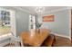 Bright dining room with natural light, modern chandelier, and ample seating at 4076 Shady Nw Cir, Lilburn, GA 30047