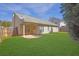 A spacious backyard featuring a well-maintained lawn, patio, and a wooden fence for privacy at 5016 Larkspur Ln, Atlanta, GA 30349