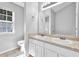 Bathroom offers double sinks with white cabinets and a large mirror at 5016 Larkspur Ln, Atlanta, GA 30349