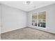 Bright bedroom featuring neutral carpet and a large window, offering ample natural light at 5016 Larkspur Ln, Atlanta, GA 30349
