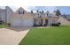 Charming one-story home with a well-maintained lawn and two-car garage at 5016 Larkspur Ln, Atlanta, GA 30349