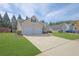 Inviting one-story home with a two-car garage and manicured lawn at 5016 Larkspur Ln, Atlanta, GA 30349