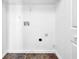 Functional laundry area with utility connections and wooden-look floor, ready for appliances at 5016 Larkspur Ln, Atlanta, GA 30349
