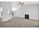 Cozy living area featuring a fireplace, ceiling fan, and open layout at 5016 Larkspur Ln, Atlanta, GA 30349