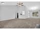 Spacious living room with fireplace, ceiling fan, and open access to dining area at 5016 Larkspur Ln, Atlanta, GA 30349