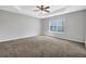 Spacious main bedroom features a ceiling fan, carpeted floors, and natural light at 5016 Larkspur Ln, Atlanta, GA 30349