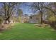 Spacious backyard with lush green grass and mature trees, offering ample space for recreation at 1124 Brandon Hill Way, Jonesboro, GA 30238