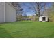 Spacious backyard with green grass and a storage shed, perfect for outdoor activities at 1124 Brandon Hill Way, Jonesboro, GA 30238