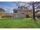 Wide backyard with lush green grass and mature trees, featuring a patio and fence at 1124 Brandon Hill Way, Jonesboro, GA 30238