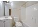 Bathroom with a white tub and toilet, vanity with sink, and mirror at 1124 Brandon Hill Way, Jonesboro, GA 30238