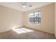 Bedroom with a ceiling fan and window providing natural light over neutral carpet at 1124 Brandon Hill Way, Jonesboro, GA 30238