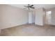 Large carpeted bedroom with a ceiling fan and attached bath at 1124 Brandon Hill Way, Jonesboro, GA 30238