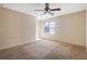Large bedroom with neutral carpet, ceiling fan, and a window at 1124 Brandon Hill Way, Jonesboro, GA 30238