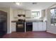Functional kitchen with white cabinetry, modern appliances, and a window overlooking the yard at 1124 Brandon Hill Way, Jonesboro, GA 30238