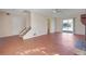 Open-concept living area with hard surface floors, staircase access, and sliding glass doors at 1124 Brandon Hill Way, Jonesboro, GA 30238