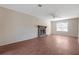 Spacious living room featuring hardwood floors, a ceiling fan, and a stone fireplace at 1124 Brandon Hill Way, Jonesboro, GA 30238