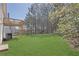 Manicured backyard with lush green lawn and wooded views with private deck at 2551 Tolliver Dr, Ellenwood, GA 30294
