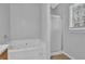 Bathroom featuring a jacuzzi tub and a stand up shower with glass door at 2551 Tolliver Dr, Ellenwood, GA 30294