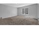 Bright bedroom with large window and neutral carpet at 2551 Tolliver Dr, Ellenwood, GA 30294