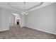 Inviting dining area featuring a modern chandelier, neutral color scheme, and plush carpeting at 2551 Tolliver Dr, Ellenwood, GA 30294