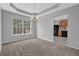 Cozy dining room featuring neutral tones, a modern chandelier, and seamless access to the kitchen at 2551 Tolliver Dr, Ellenwood, GA 30294
