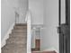 Bright entryway with neutral paint, carpeted stairs, and direct access to the upper and lower levels at 2551 Tolliver Dr, Ellenwood, GA 30294