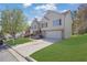 Attractive two-story home featuring a brick and siding exterior, well-manicured lawn, and attached garage at 2551 Tolliver Dr, Ellenwood, GA 30294