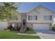 Charming two-story home featuring a brick and vinyl facade, attached garage, and well-maintained front yard at 2551 Tolliver Dr, Ellenwood, GA 30294