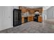 Traditional kitchen with tile floors, wood cabinets, and black appliances at 2551 Tolliver Dr, Ellenwood, GA 30294
