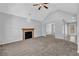 Spacious living room with vaulted ceiling, fireplace, neutral paint, and access to dining and kitchen areas at 2551 Tolliver Dr, Ellenwood, GA 30294