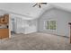 Open-concept living area with a fireplace, neutral paint, and seamless flow to the kitchen and dining spaces at 2551 Tolliver Dr, Ellenwood, GA 30294