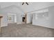 Bright open-concept living area featuring a fireplace, neutral decor, and access to the kitchen at 2551 Tolliver Dr, Ellenwood, GA 30294