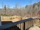 Deck overlooking spacious backyard, surrounded by tall trees and a wooden fence at 3836 Saddle Hill Way, Douglasville, GA 30135