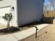 Exterior view of a house showing the side yard with a concrete pathway, landscaping and a wooden fence at 3836 Saddle Hill Way, Douglasville, GA 30135