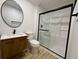 Modern bathroom with glass shower, wood vanity, and black accents at 3836 Saddle Hill Way, Douglasville, GA 30135